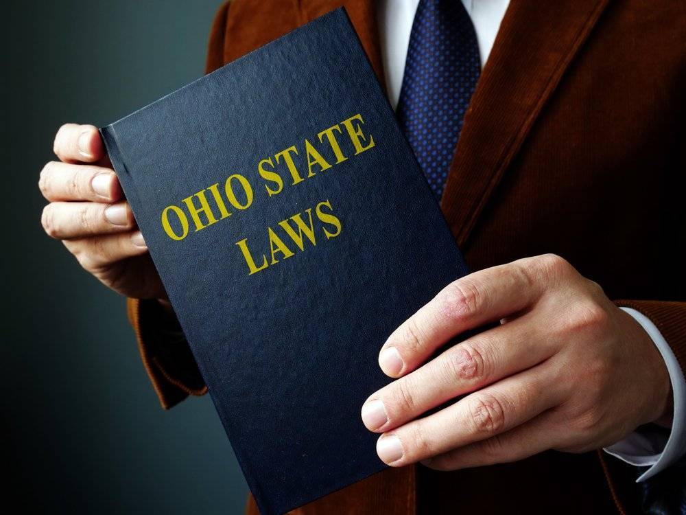 Man holding Ohio State Laws book