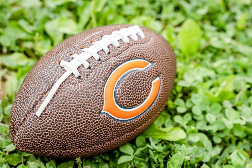 Chicago Bears logo on football on green grass