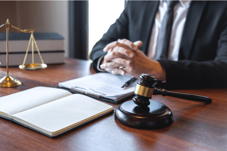 Lawyer at a desk with paperwork and a gavel